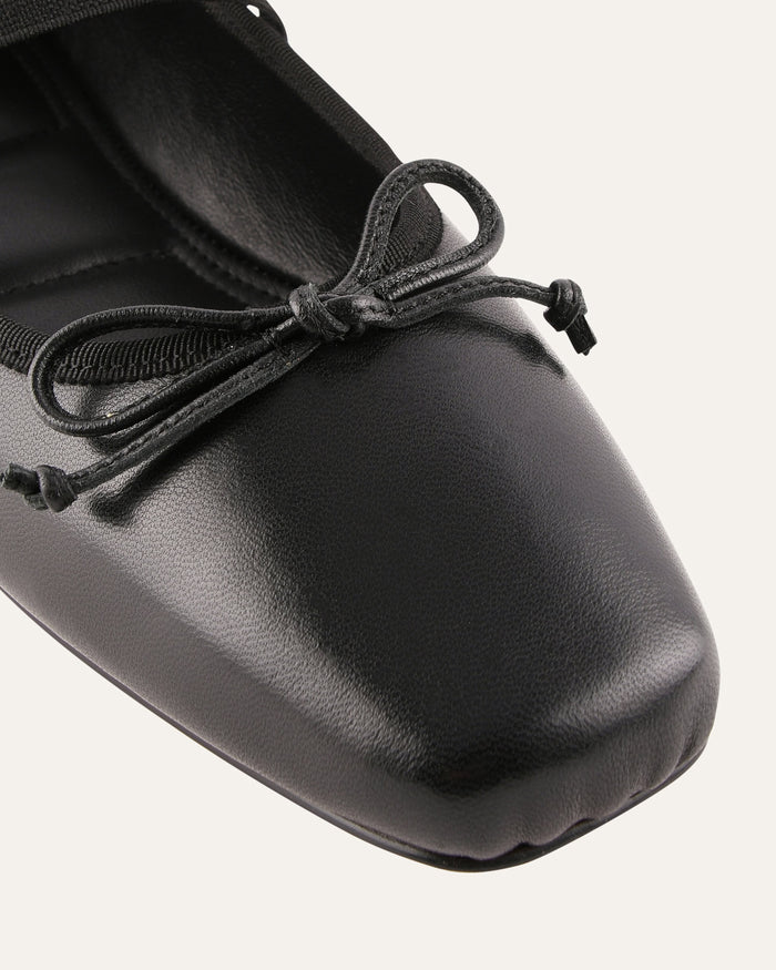 Black ballet shoe with a soft sole on a white background
