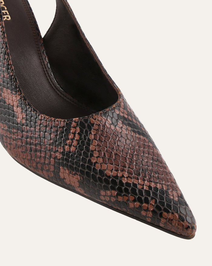 Pointed-toe shoe with snake print pattern on a white background