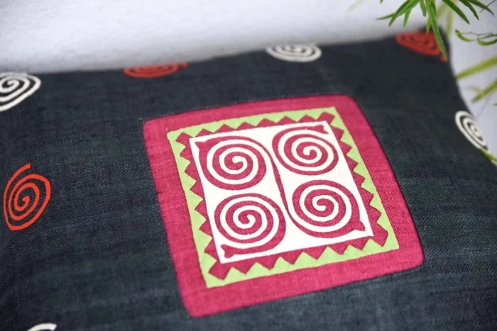 Close-up of pink spiral patch with zigzag border on hemp fabric