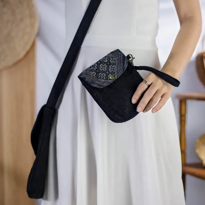 Black hemp flip phone belt bag with H’Mong patch, worn across the waist by model, versatile bag.
