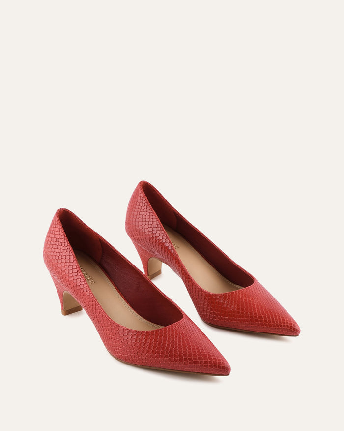 Red high-heeled shoes with a textured pattern on a light background