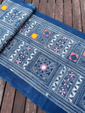 Block print batik with embroidery and appliqué on cotton in geometric flowery pattern
