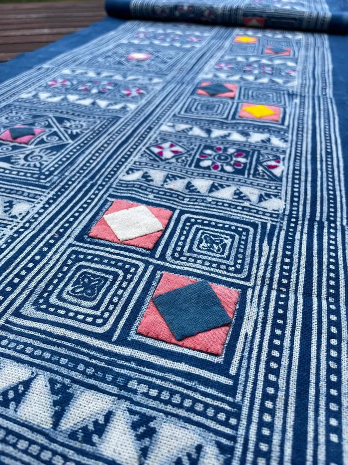 Block print batik with embroidery and appliqué on cotton in geometric flowery pattern