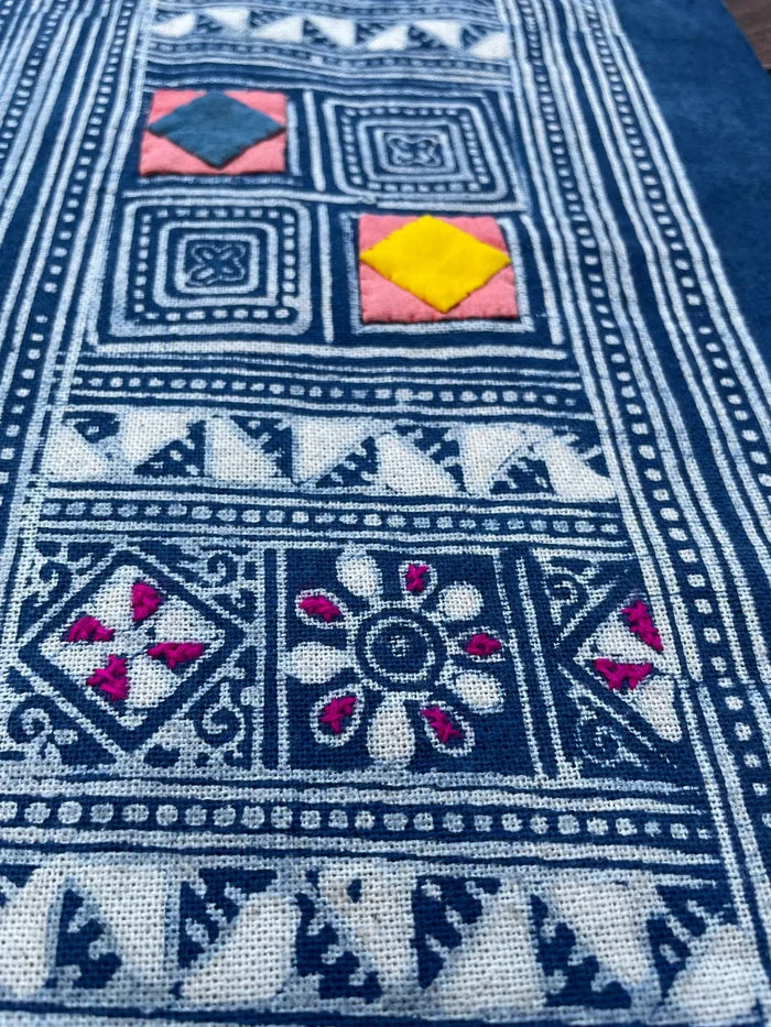 Block print batik with embroidery and appliqué on cotton in geometric flowery pattern