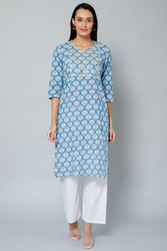 Full view of the Blue and White Embroidery & Sequins Kurti Cotton Kurti on a model, highlighting its A-line fit and l...