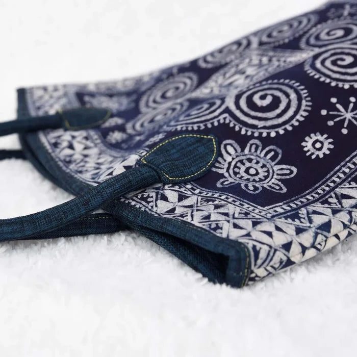 Vindigo tote side view showing floral and spiral batik