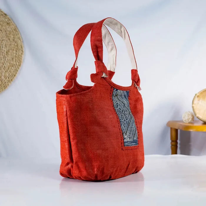 Side view of red hemp bunny ear handbag featuring vintage H’Mong patch, sustainable handmade design