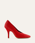 Red high-heeled shoe on a light beige background