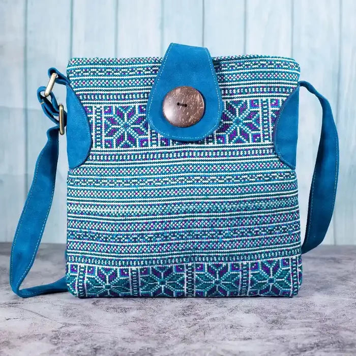 Vindigo blue embroidered crossbody bag front view with H’mong motifs and coconut button