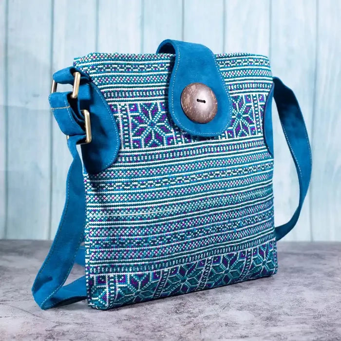 Vindigo blue embroidered crossbody bag side angle with cobalt faux leather strap