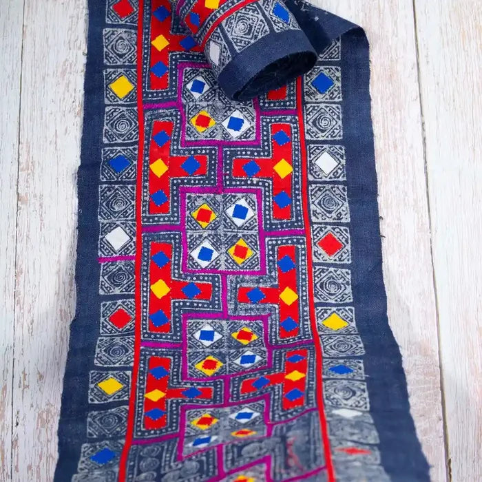 Vindigo indigo fabric roll with embroidery, top-down view