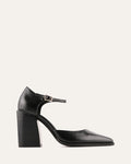 Black high-heeled shoe with a strap on a light gray background