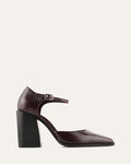 Brown high-heeled shoe with a black block heel on a light beige background