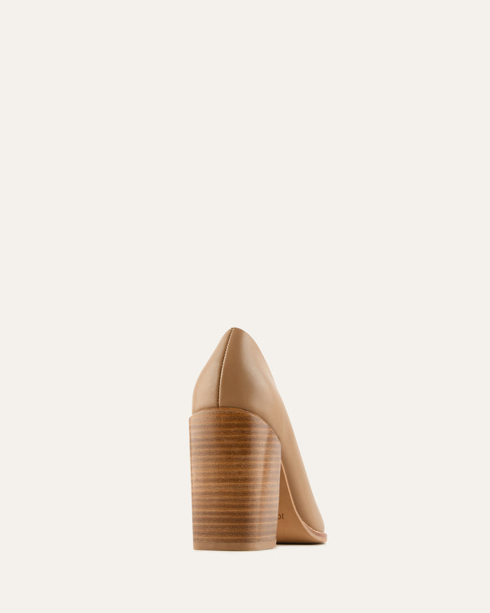 Beige high-heeled shoe on a light beige background