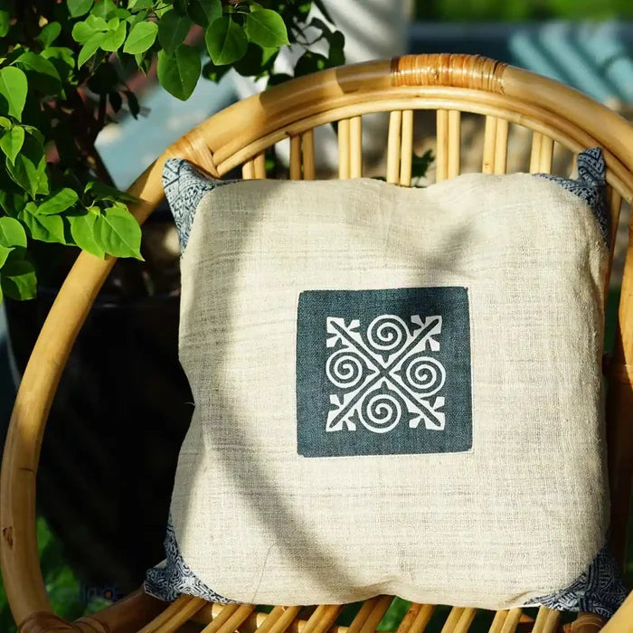 Natural hemp cushion on rattan chair with indigo detail