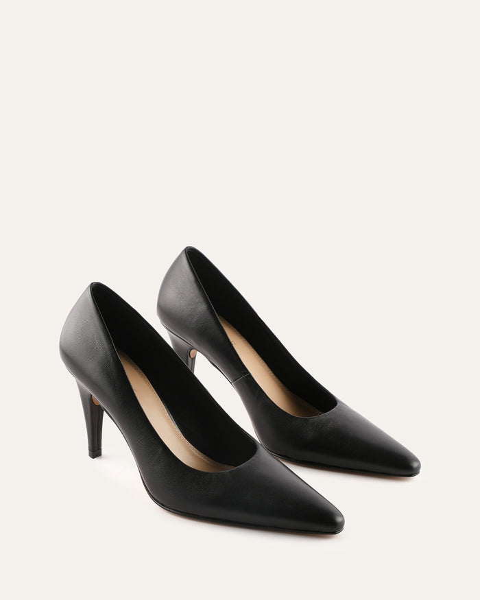 Pair of black high-heeled shoes on a light gray background