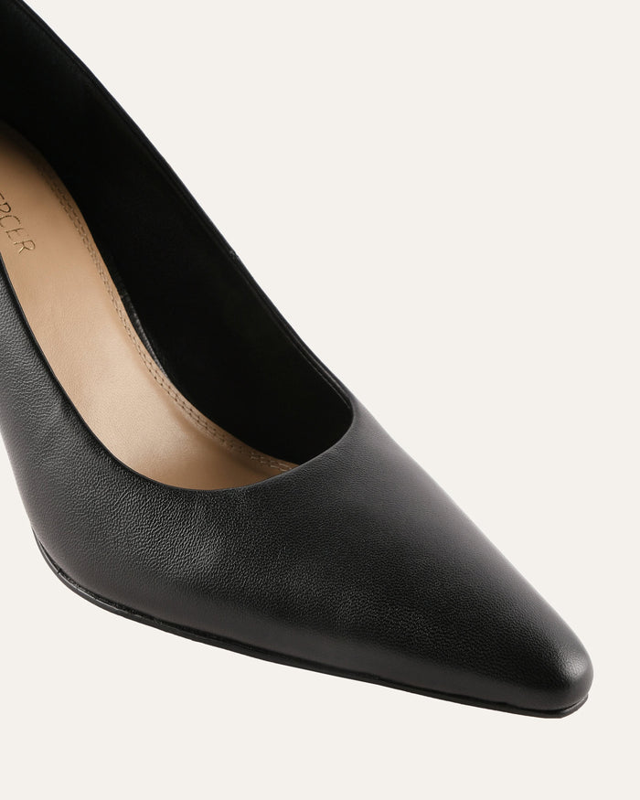 Black pointed-toe shoe on a light gray background