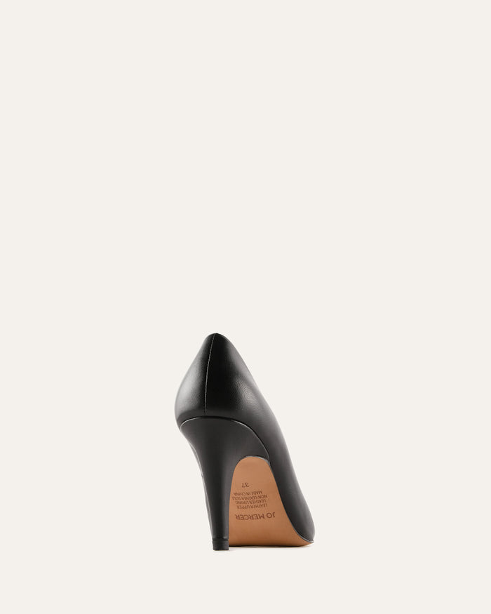 Black high-heeled shoe with a brown sole on a white background