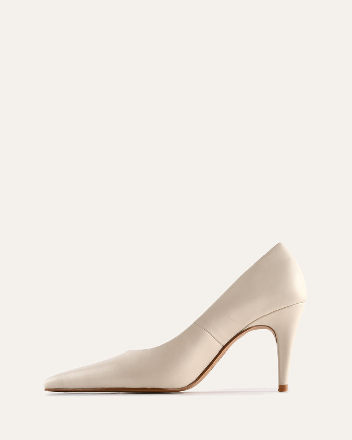Beige high-heeled shoe on a light beige background