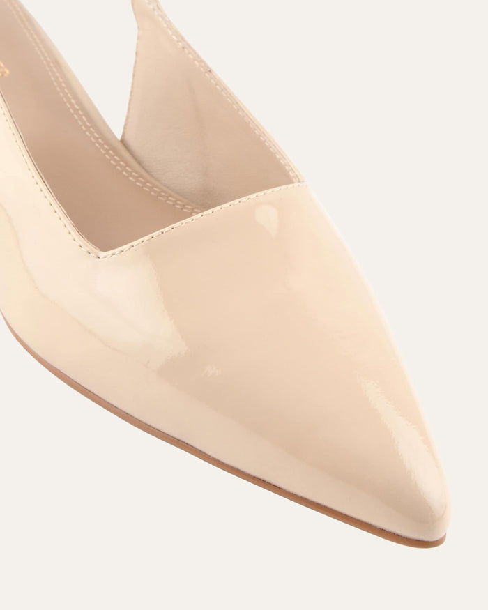 Beige pointed-toe shoe on a light gray background