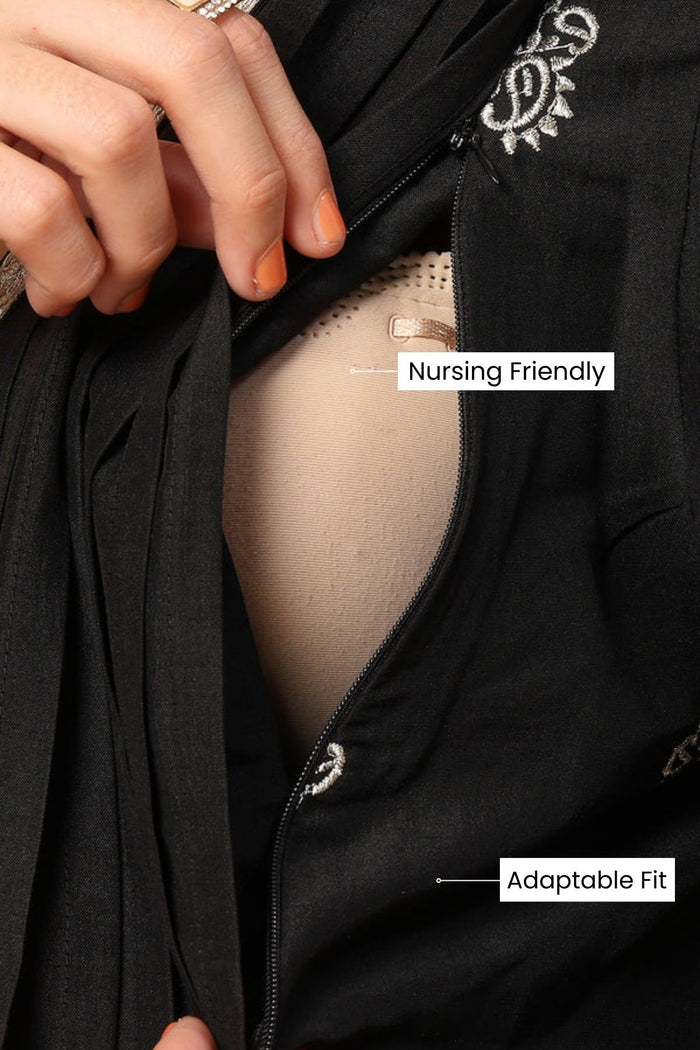 Full-length shot of model wearing the Elegant Black Festive Suit Set. Emphasizes the comfortable Relaxed Maternity.