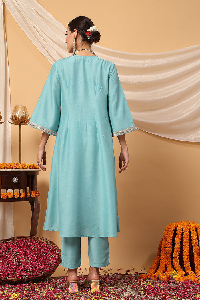 Model action shot of the Elegant Turquoise Festive Suit Set, demonstrating ease of movement and fit.