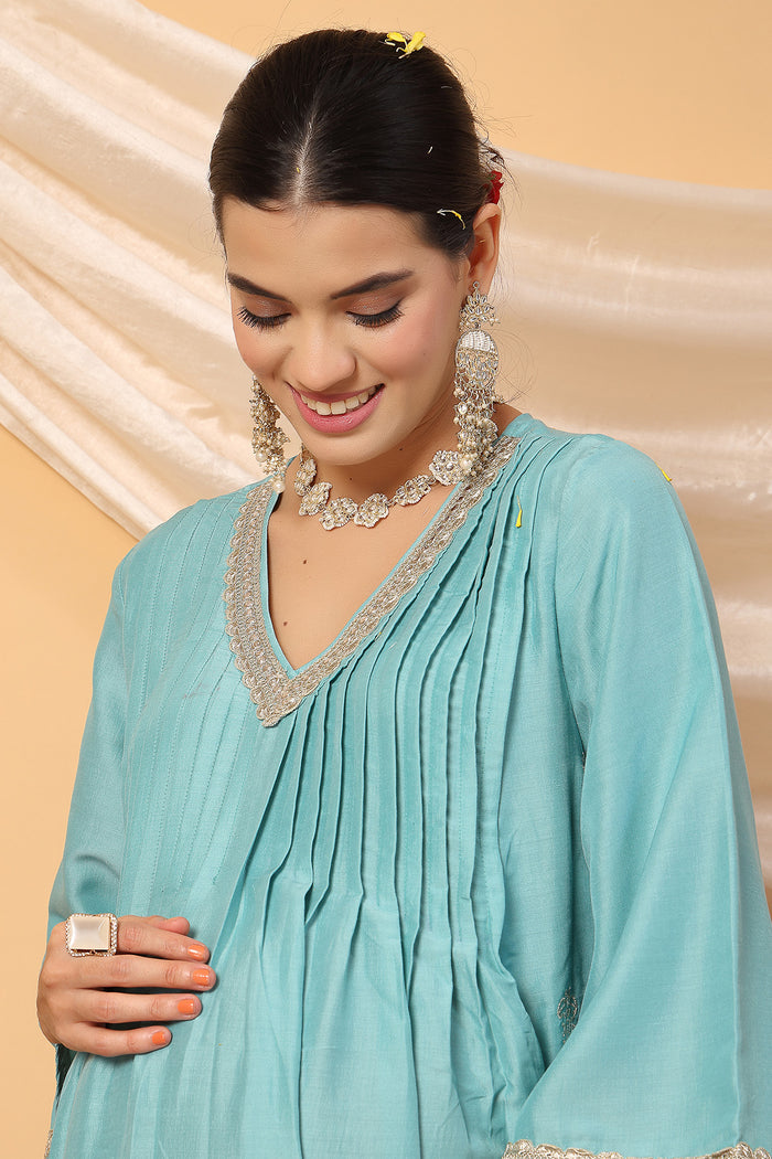 High-quality image of the Polyester texture and finish of the Elegant Turquoise Festive Suit Set.