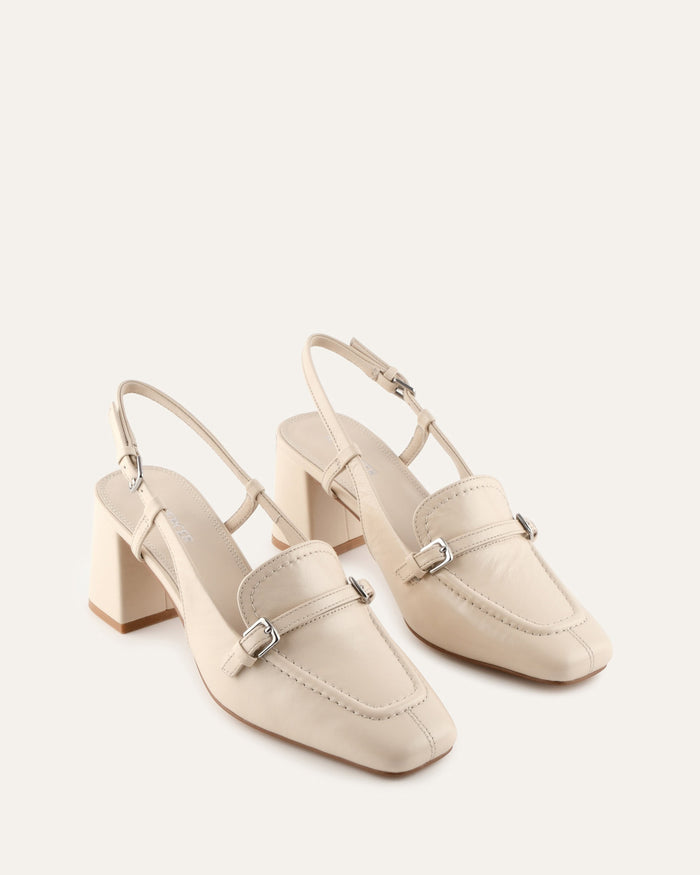 Pair of beige high-heeled shoes on a white background