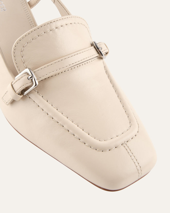 Beige sandal with a buckle on a light gray background