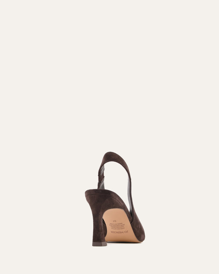 Brown leather shoe with a strap on a light beige background