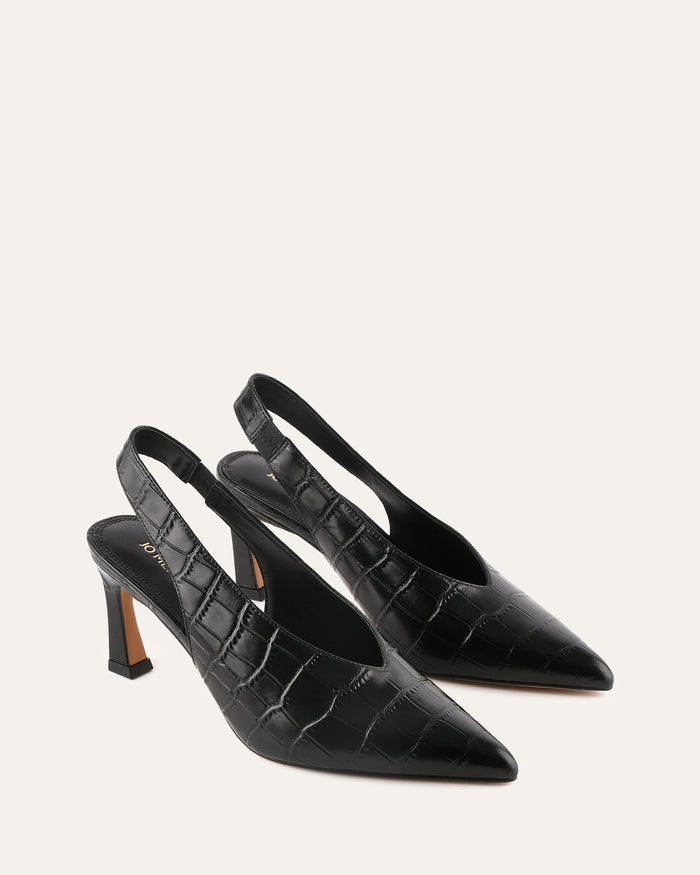 Black crocodile-patterned high-heeled shoes on a light gray background