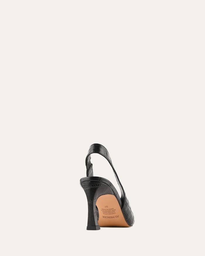 Black high-heeled shoe with brown sole on a white background