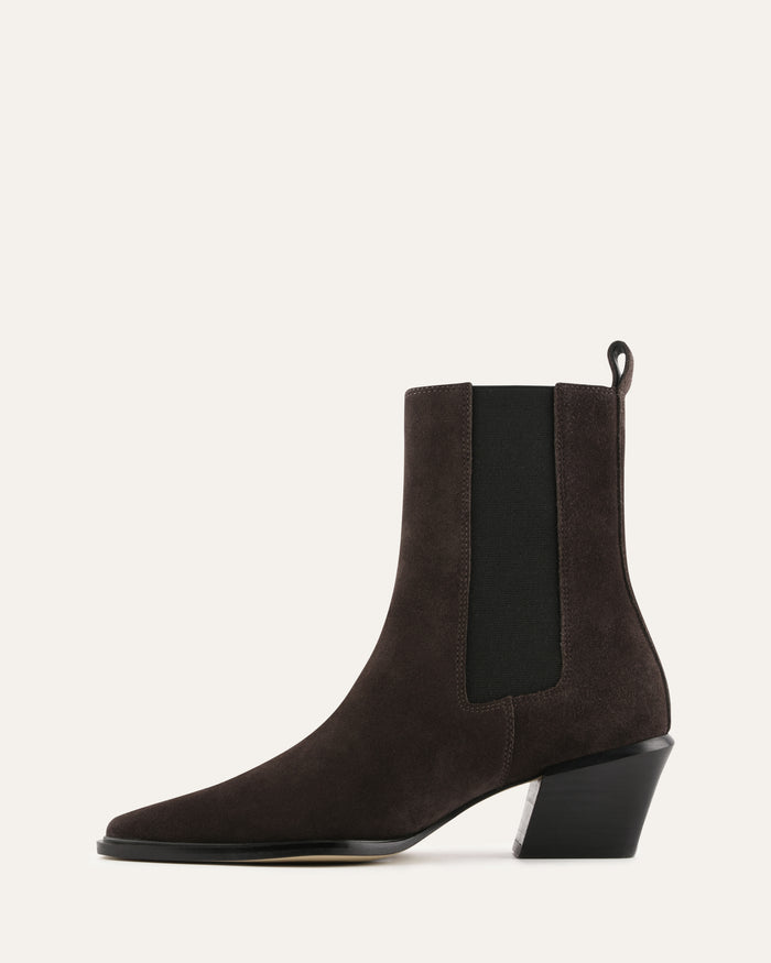 Brown suede ankle boots with black elastic side panels on a white background