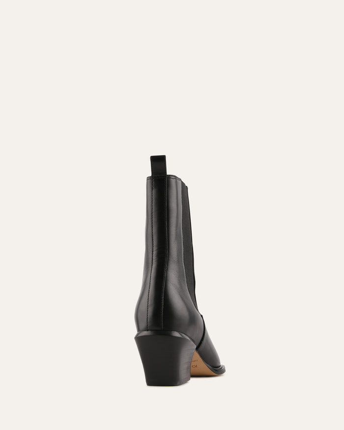 Black ankle boot on a light gray background