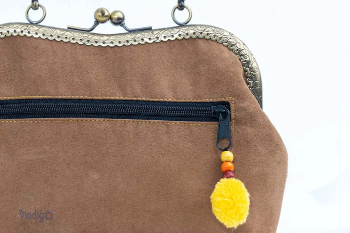 Vindigo handbag close-up of zipper pocket with tassel detail