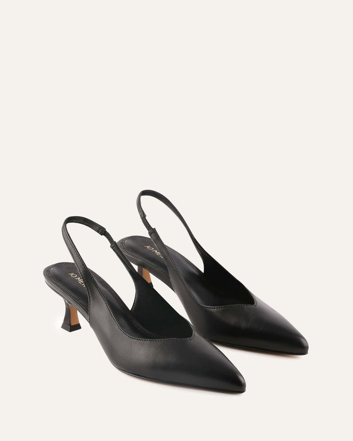 Pair of black slingback heels on a light gray background