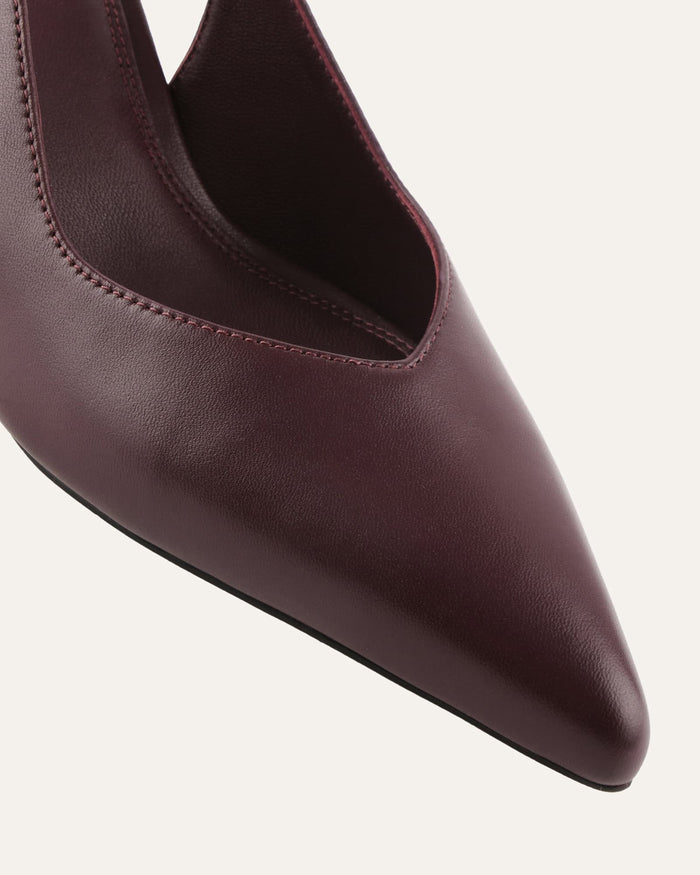 Maroon pointed-toe shoe on a light gray background