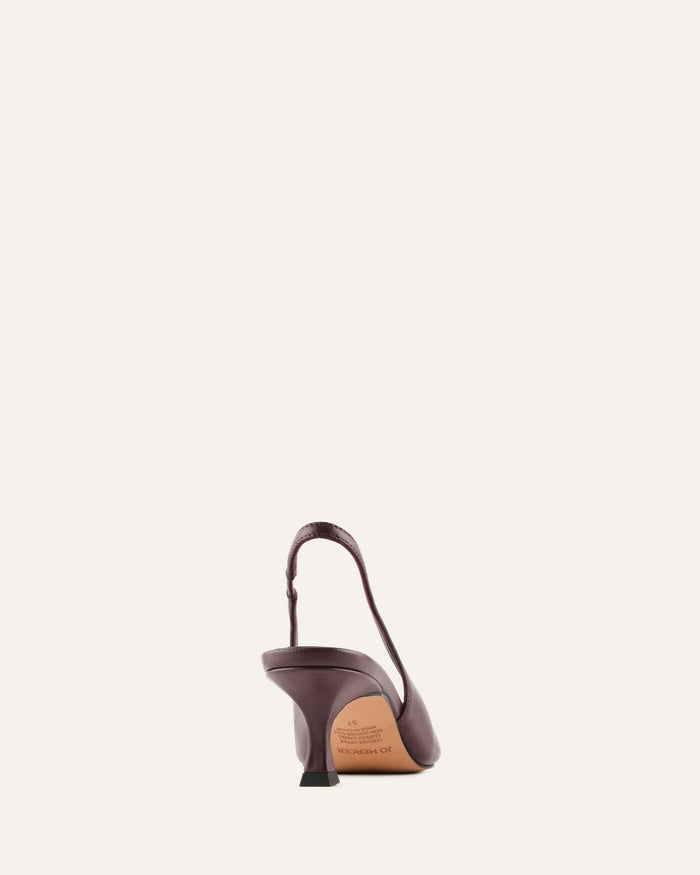 Brown high-heeled shoe with a strap on a light beige background