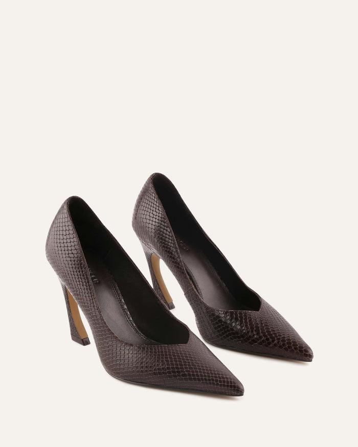 Pair of brown pointed high-heeled shoes on a light gray background