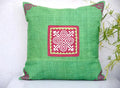 Vindigo green cushion cover with red square spiral motif centered