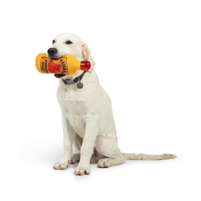 Dog with Hairball Cinnamon Whisky Dog Toy on a white background.