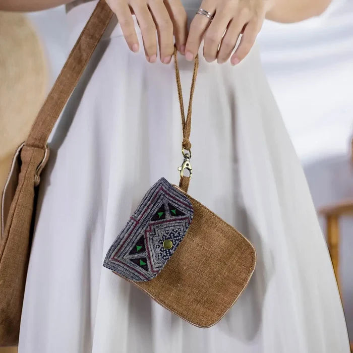 Side view of model with brown hemp flip phone belt bag and vintage patch.