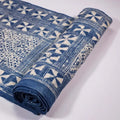 Vindigo indigo fabric roll with tribal triangle grid pattern, partially rolled