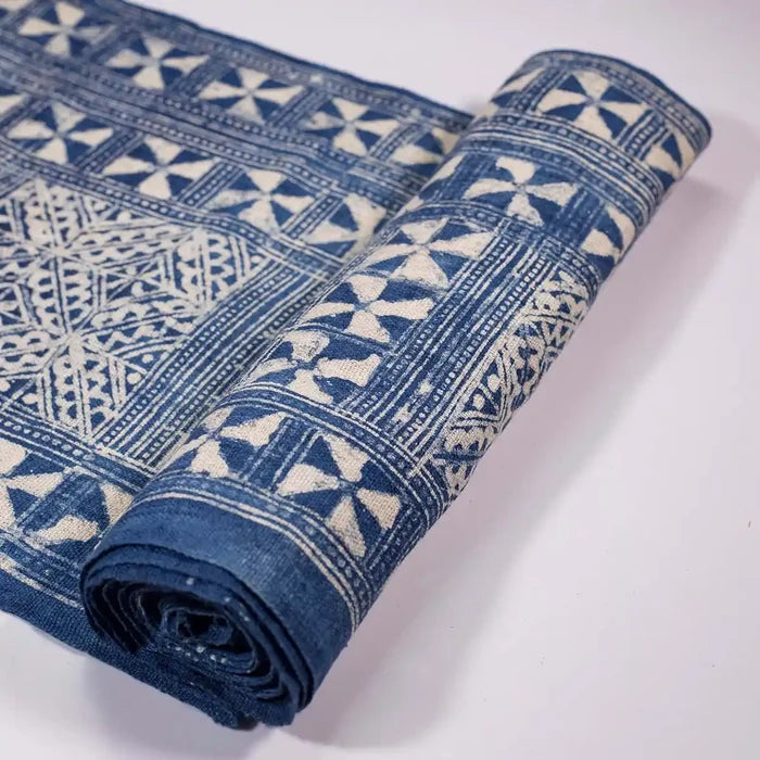 Vindigo indigo fabric roll with tribal triangle grid pattern, partially rolled