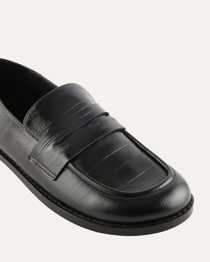 Black loafer shoe on a white background