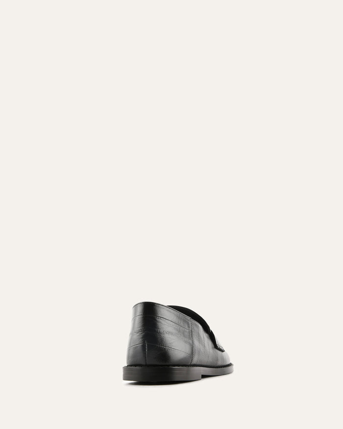 Black leather shoe on a white background