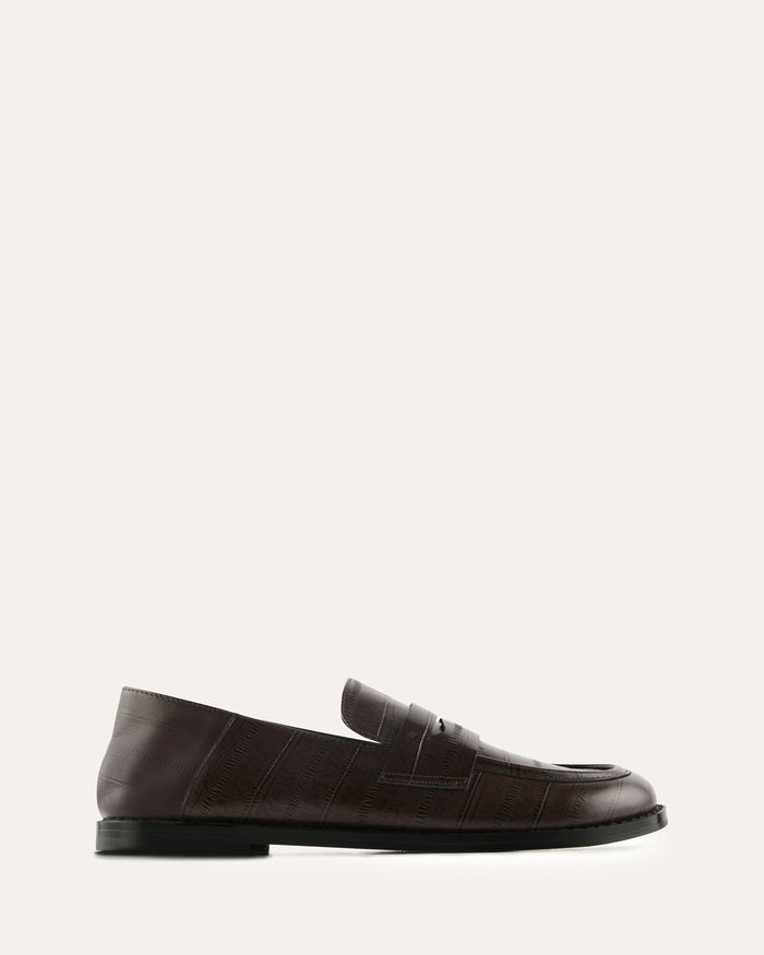 Beige loafer with a buckle on a white background