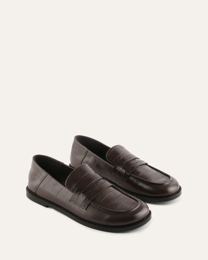Pair of brown loafers on a white background
