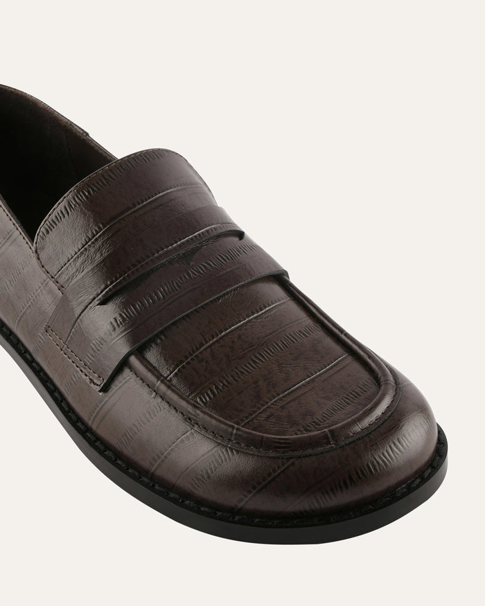 Brown loafer shoe on a white background