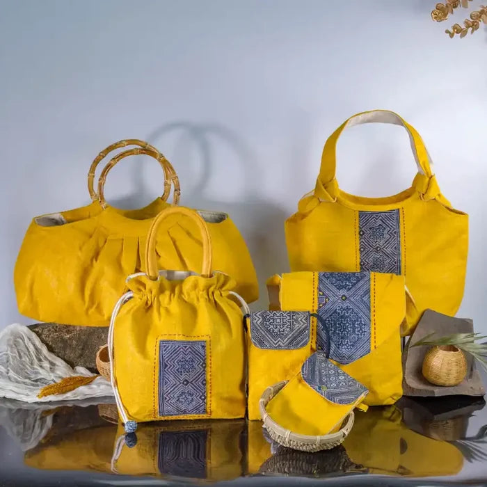 Eco-friendly yellow hemp handbags with bamboo handles and indigo patchwork, artisan handmade